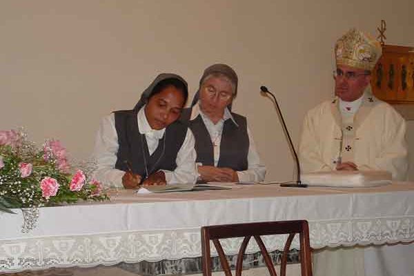 Sr Suchita signs the Act of Profession in the presence of His Grace the Archbishop and Sr Bernadette Galea