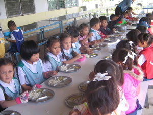 Sisters serving meal to the school children
