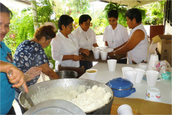 The Sisters together with the lay persons prepare to serve the sick with a hot meal